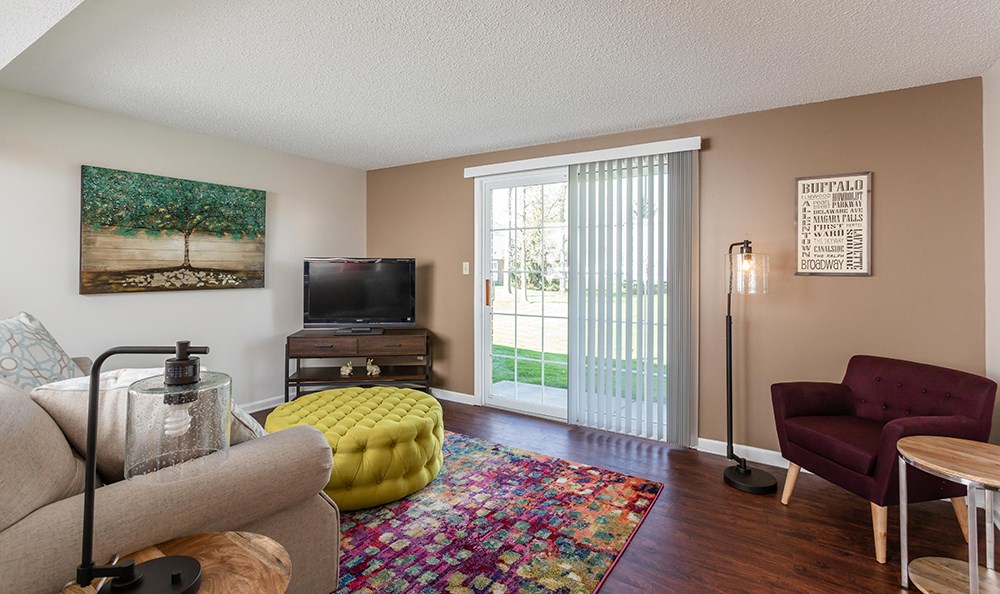 a living room with a tv and a door to a patio