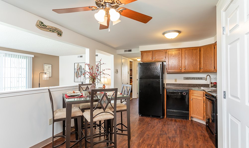 a kitchen and dining room with a table and chairs