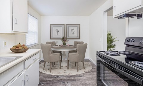 a kitchen and dining room with a table and chairs