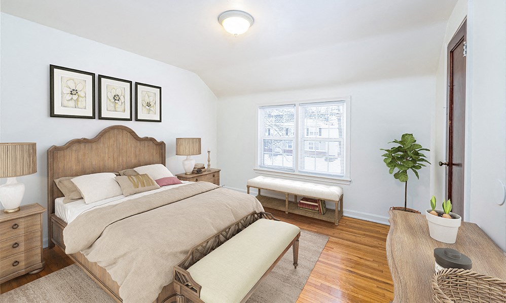 a bedroom with a bed and a window