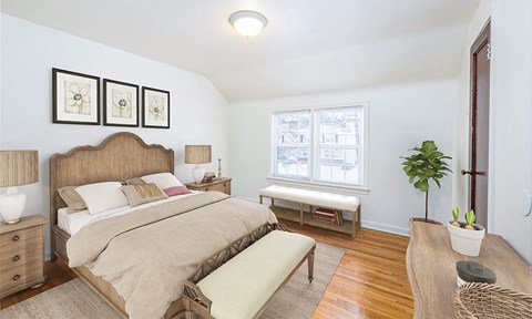 a bedroom with a bed and a window