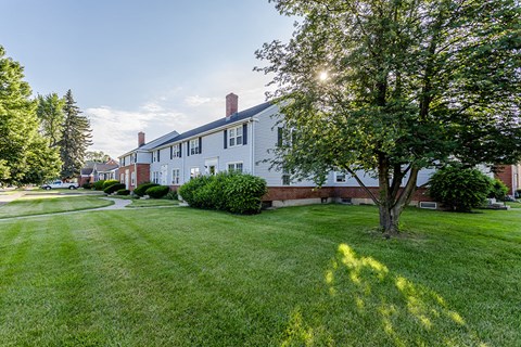 a large yard in front of a white house