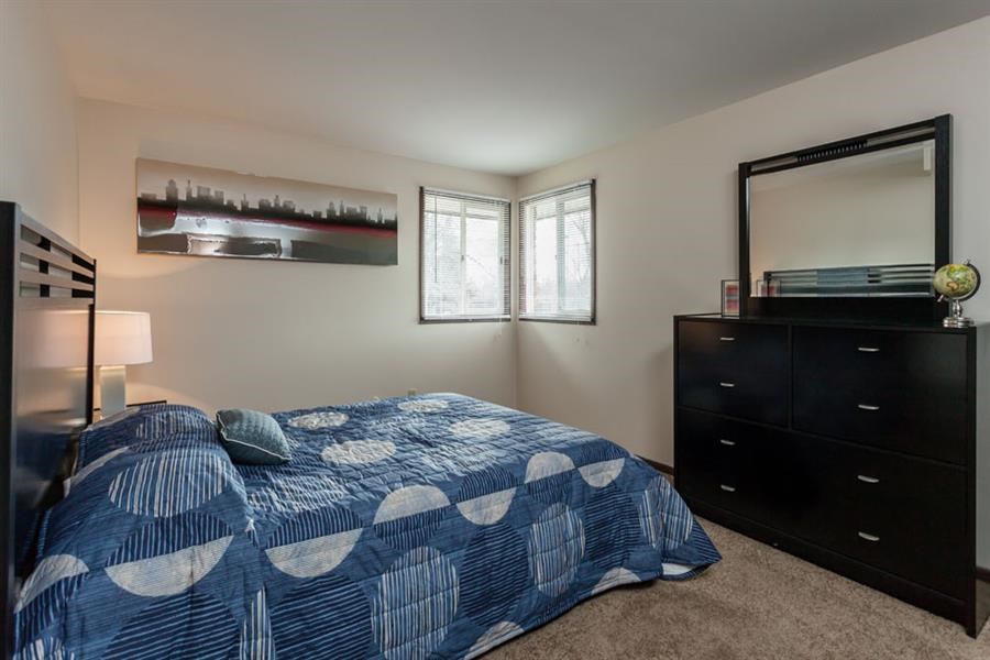 a bedroom with a bed and a dresser