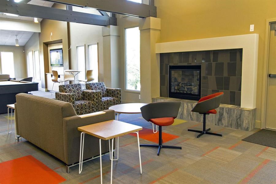 a living room with couches and tables and a fireplace