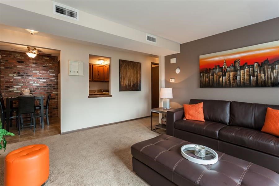 a living room with a leather couch and a table