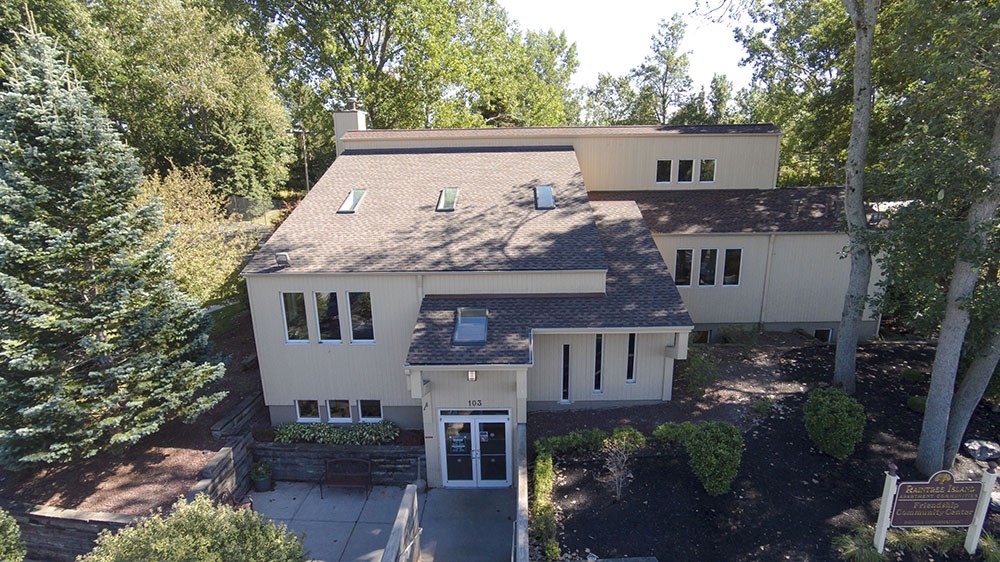 an aerial view of a white house and trees