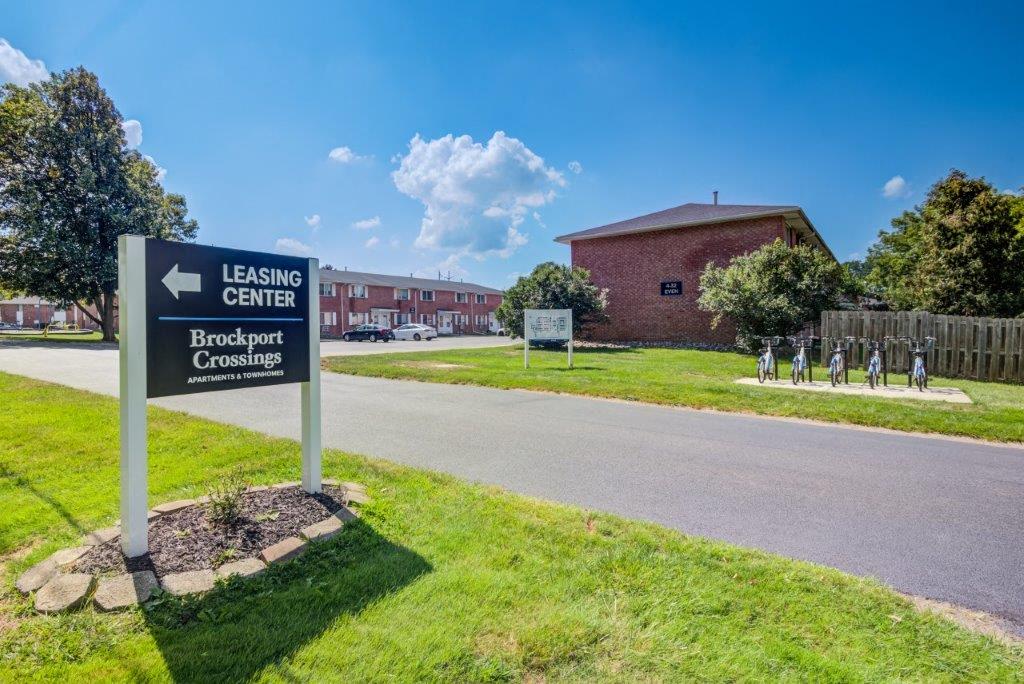 exterior photo of sign leading to leasing office