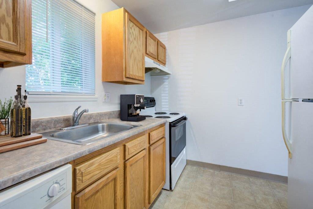 kitchen with oak cabinets and white appliances