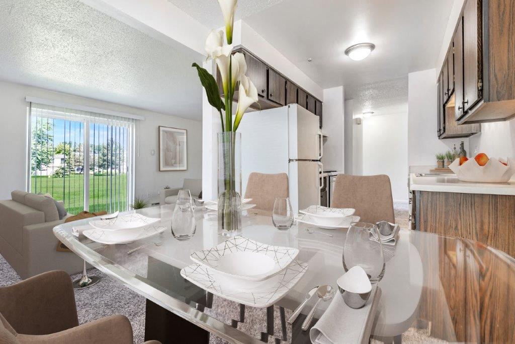 dining area next to classic kitchen. living area with carpet in background
