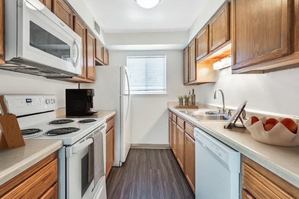 Kitchen with maple cabinets, white appliances
