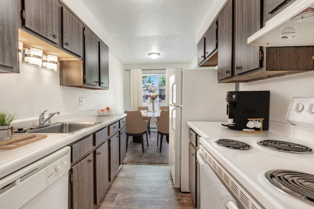 kitchen with classic brown cabinets and white appliances
