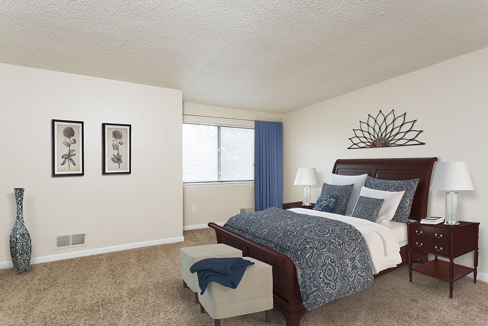 staged bedroom with wall to wall carpeting