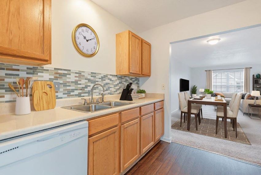 a kitchen with a dishwasher and a clock on the wall