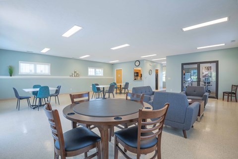 a large room with a round table and chairs