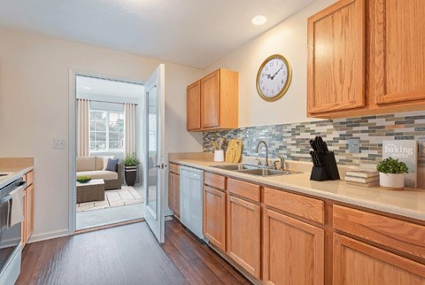 a kitchen with a sink and a clock on the wall