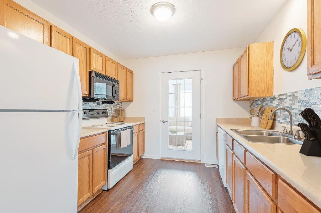 a kitchen with wooden cabinets and a refrigerator