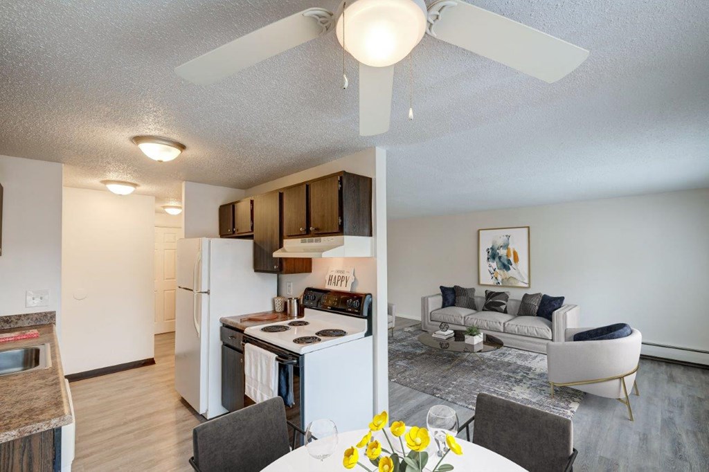a kitchen and living room with a ceiling fan