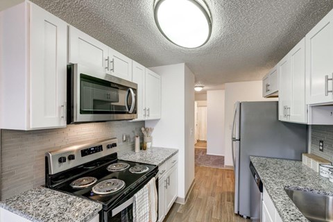 a kitchen with stainless steel appliances and granite counter tops