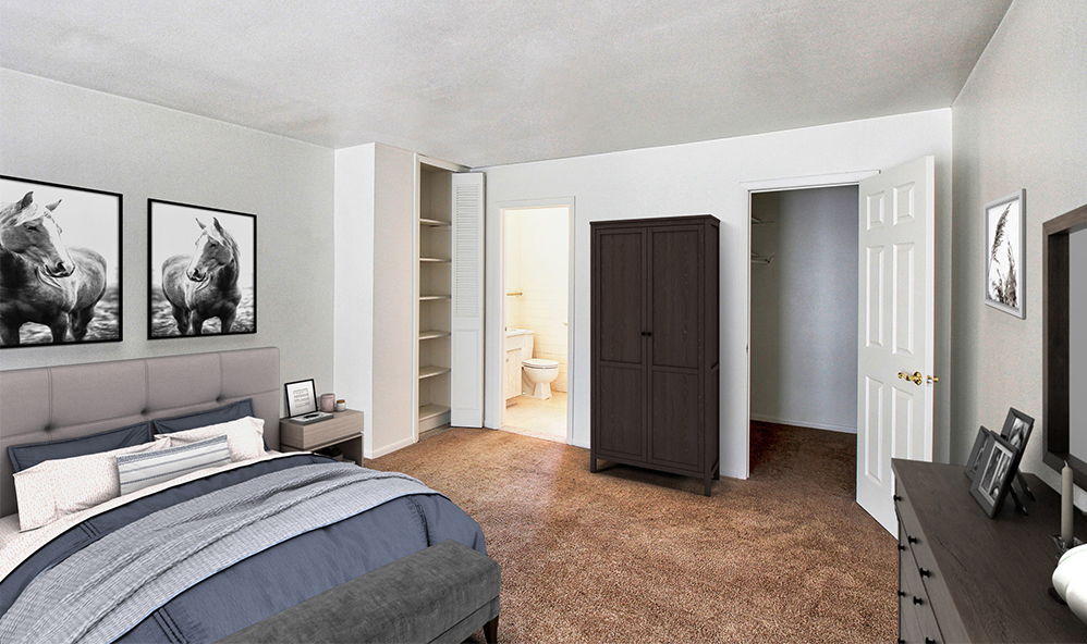 staged bedroom with wall to wall carpeting and 2 closets