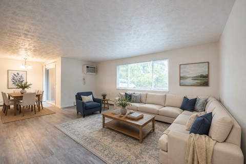 A living room with a couch, chairs, and a coffee table.