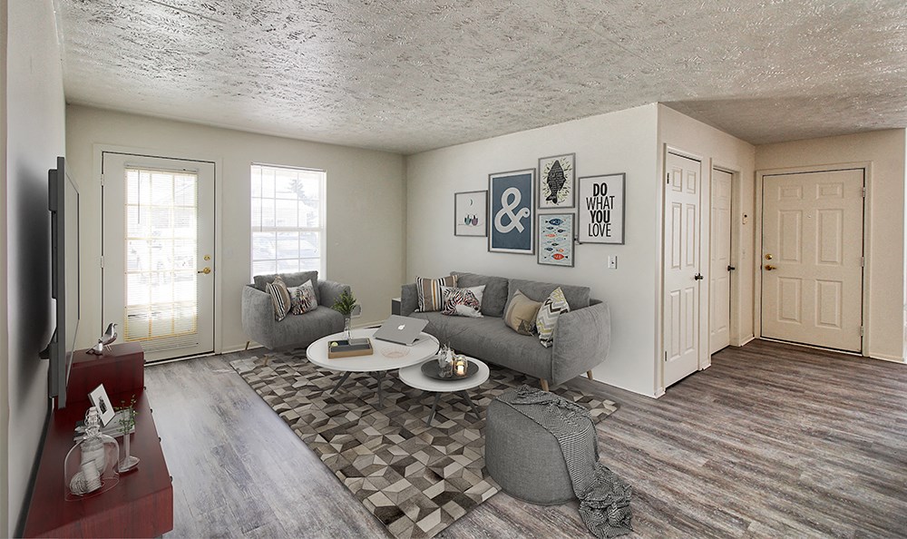 an open living room with couches and a coffee table