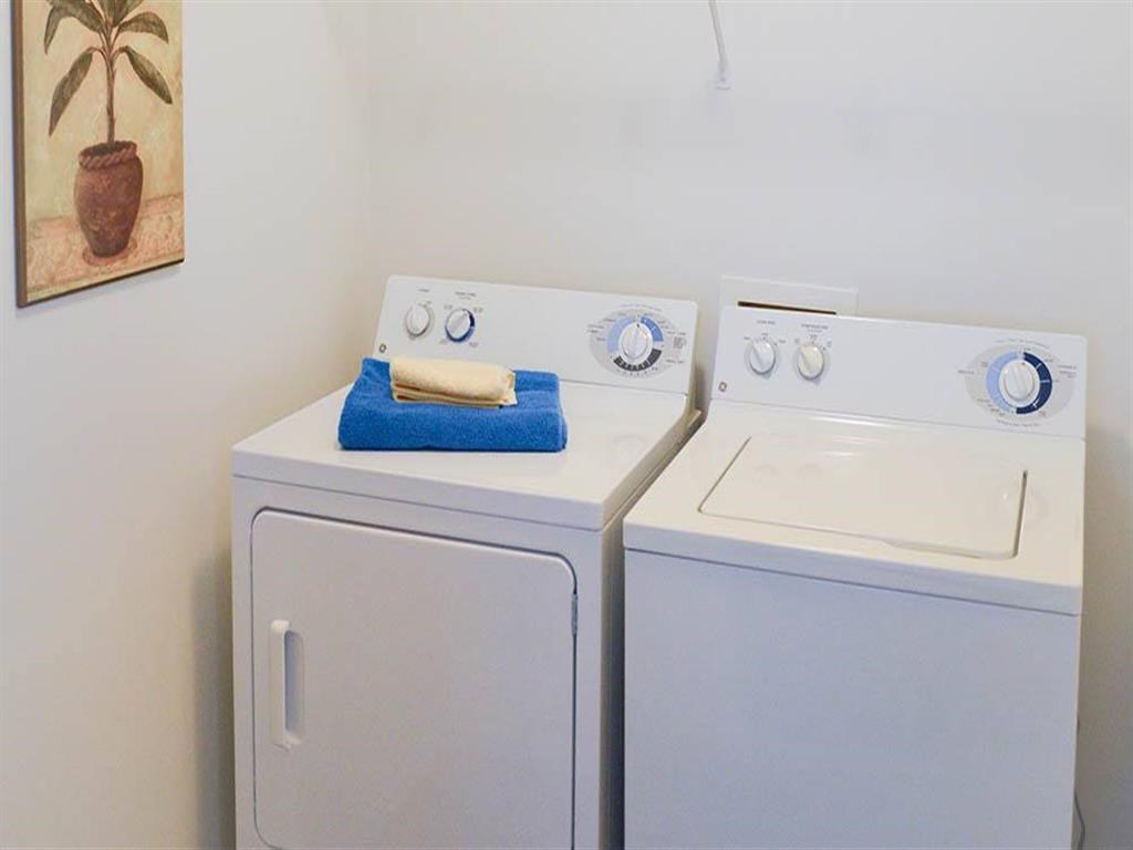 a white washer and dryer next to each other in a laundry room