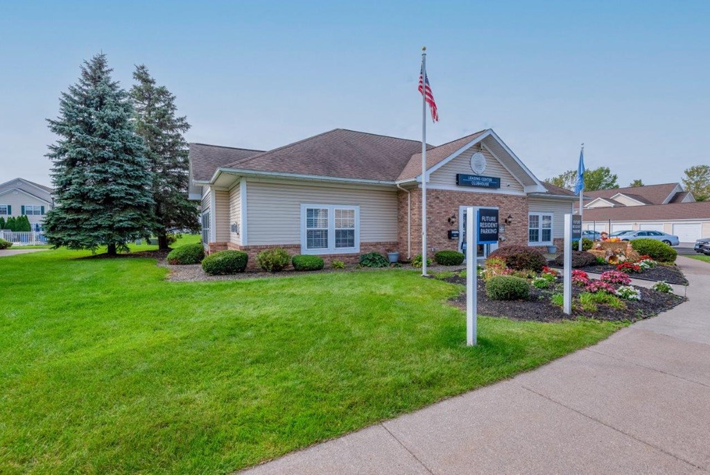 the front of a house with an flag on a pole and a lawn