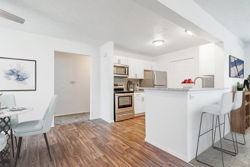 an open kitchen and dining room with a bar and a table