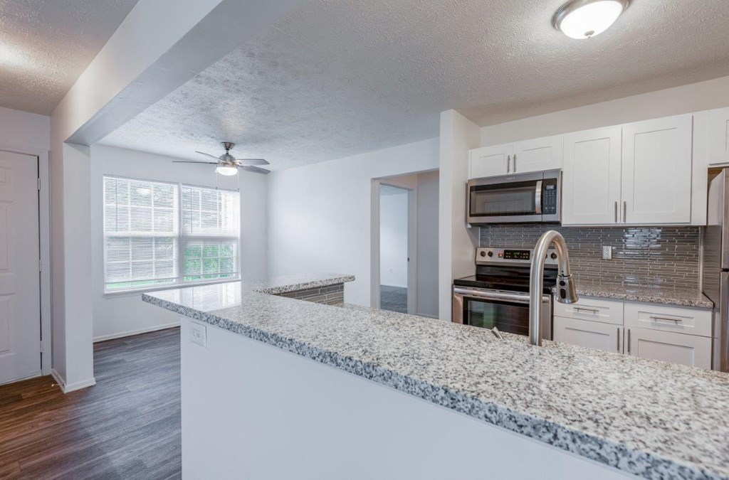 a kitchen with a granite counter top and a stainless steel stove