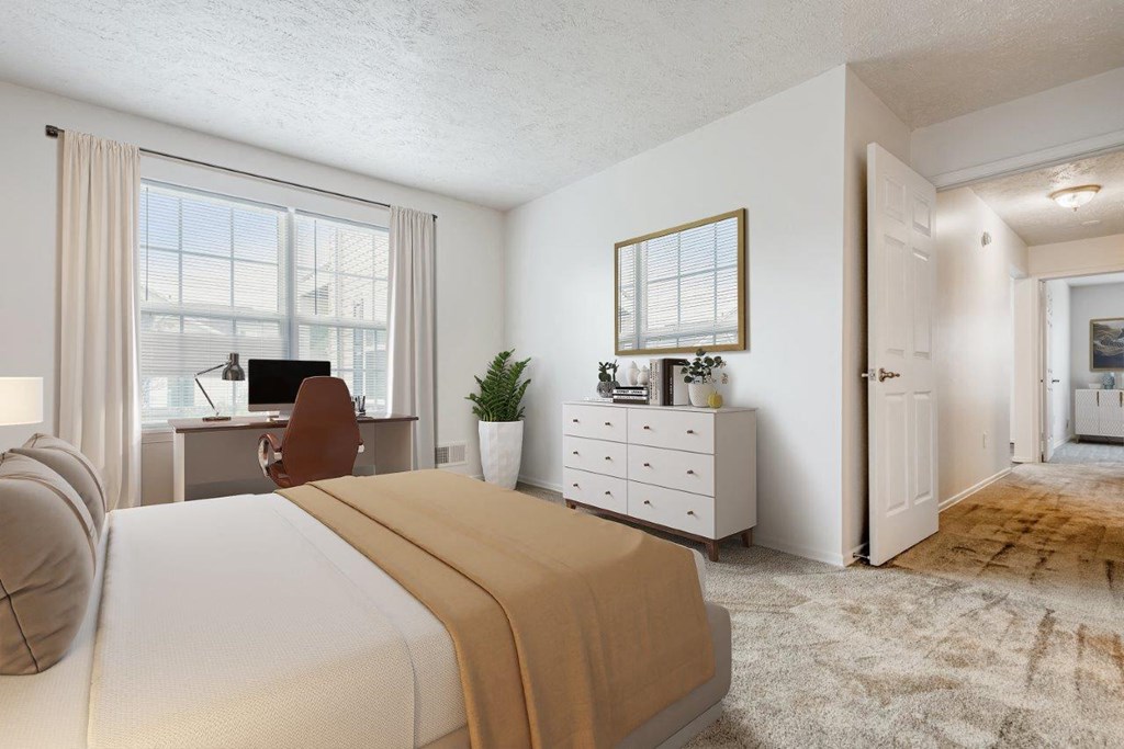 a bedroom with a bed and a desk