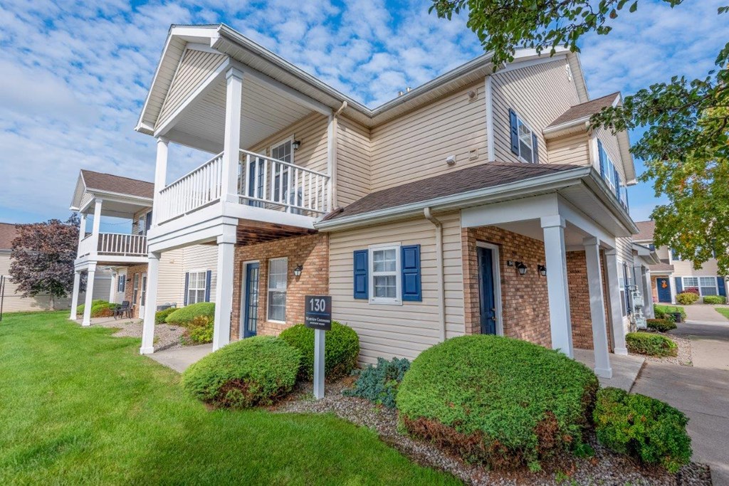a house with a yard and a sign in front of it