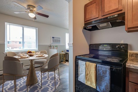 a kitchen and a dining room with a table and chairs