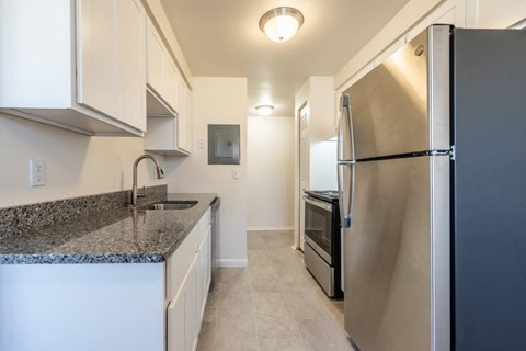 a kitchen with stainless steel appliances and granite counter tops