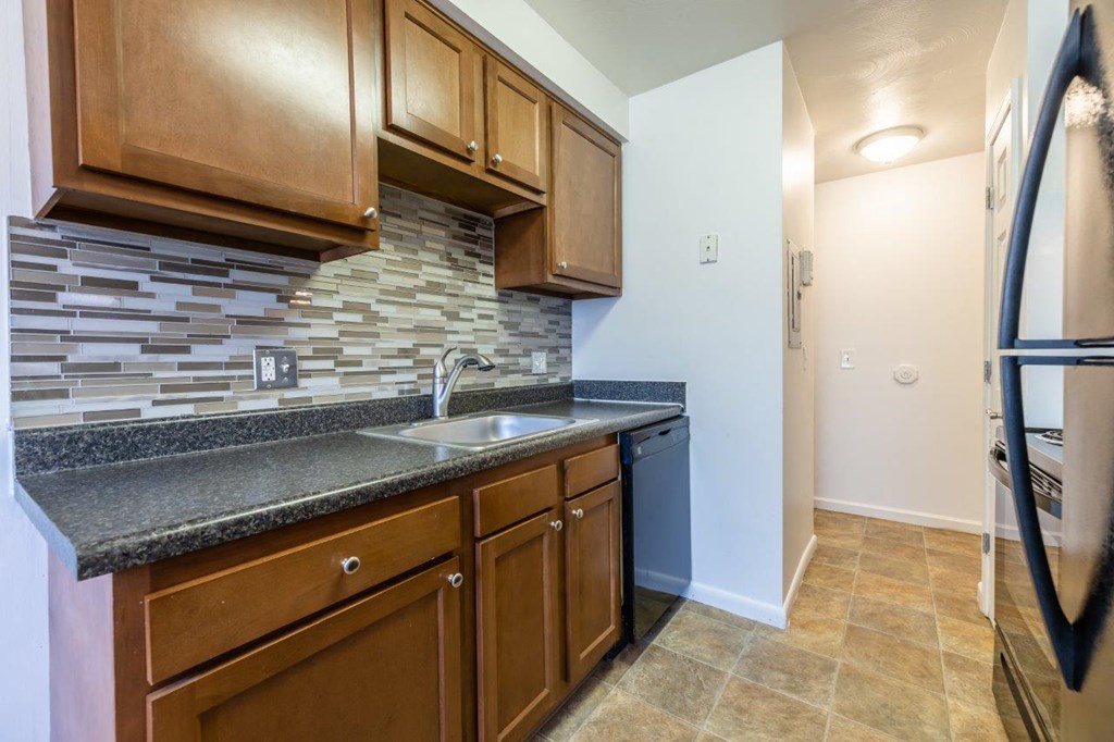 a kitchen with a sink and a refrigerator