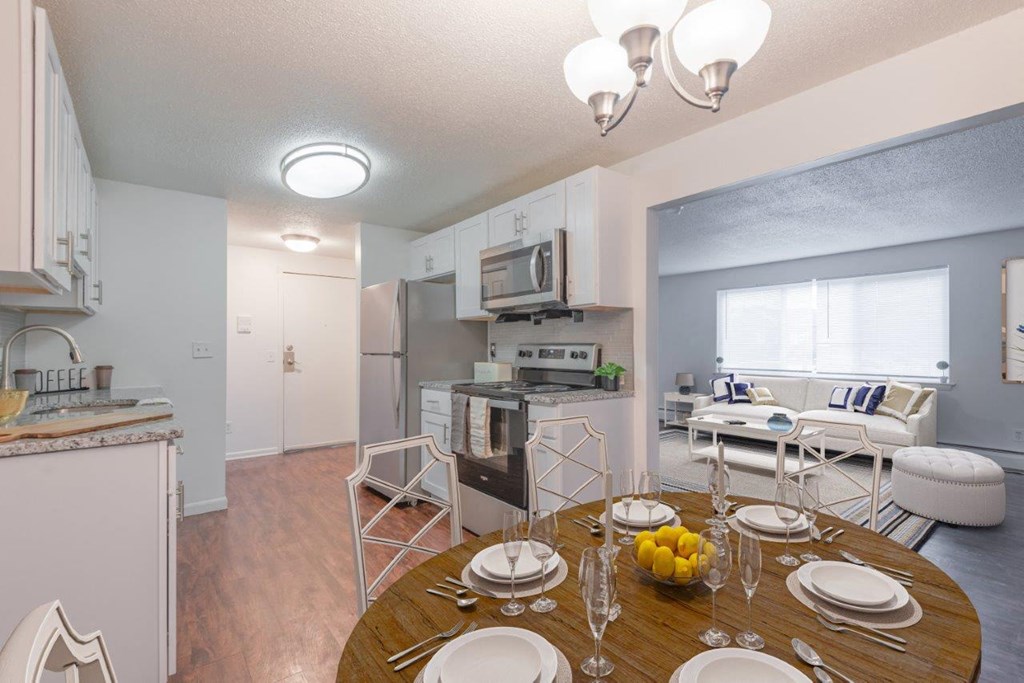 a kitchen and dining room with a table and chairs