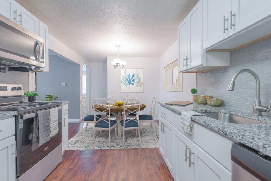 an open kitchen and dining room with a table and chairs