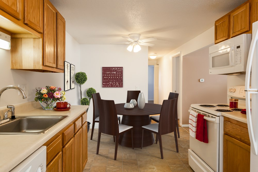 a kitchen and dining room with a table and chairs