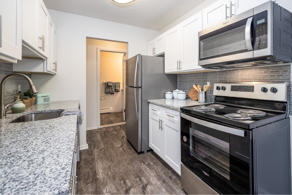 a kitchen with stainless steel appliances and granite counter tops