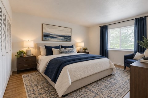 A bedroom with a large bed and a painting on the wall.