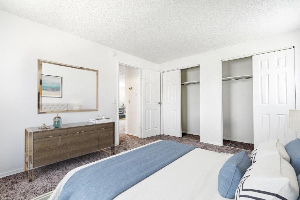 a bedroom with a bed and a dresser