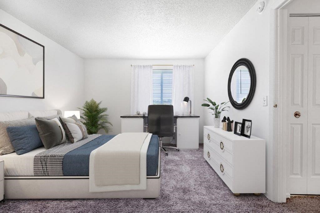 a bedroom with a bed and a desk