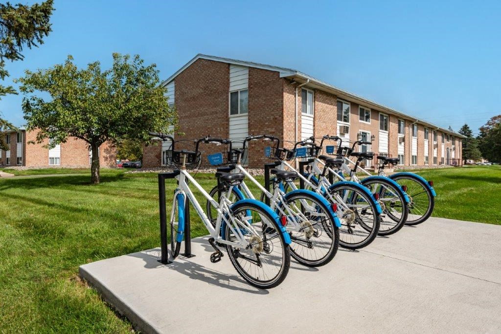 a row of bikes parked in front of a building