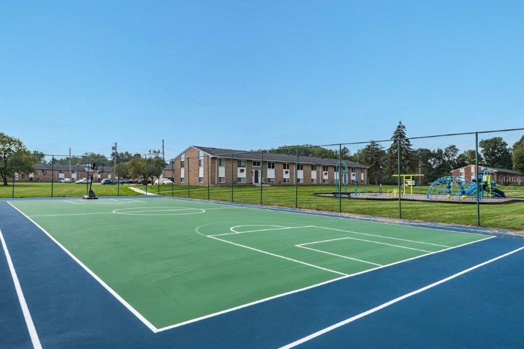 a tennis court with a building in the background
