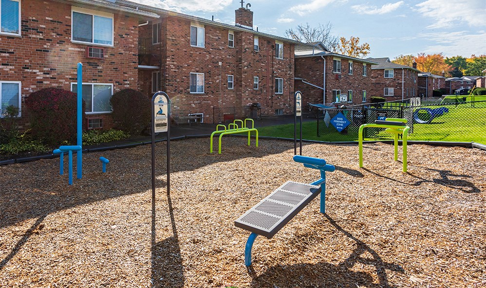 a picnic table and swing set in a playground