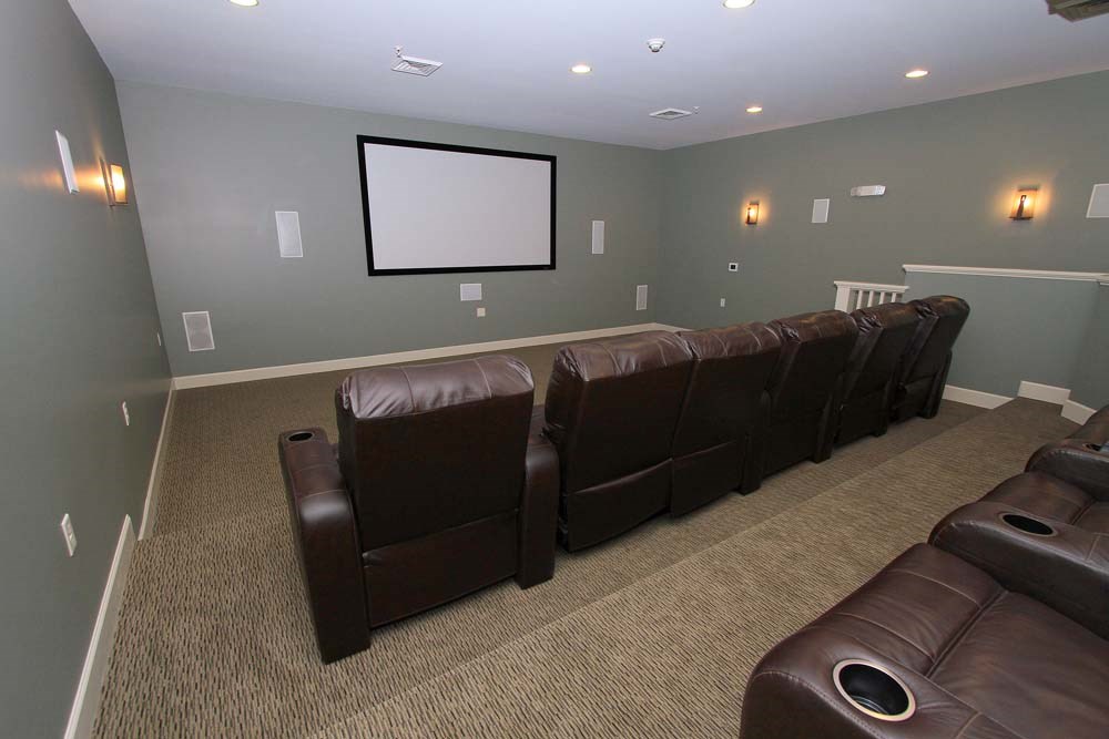 a living room with leather couches and a tv