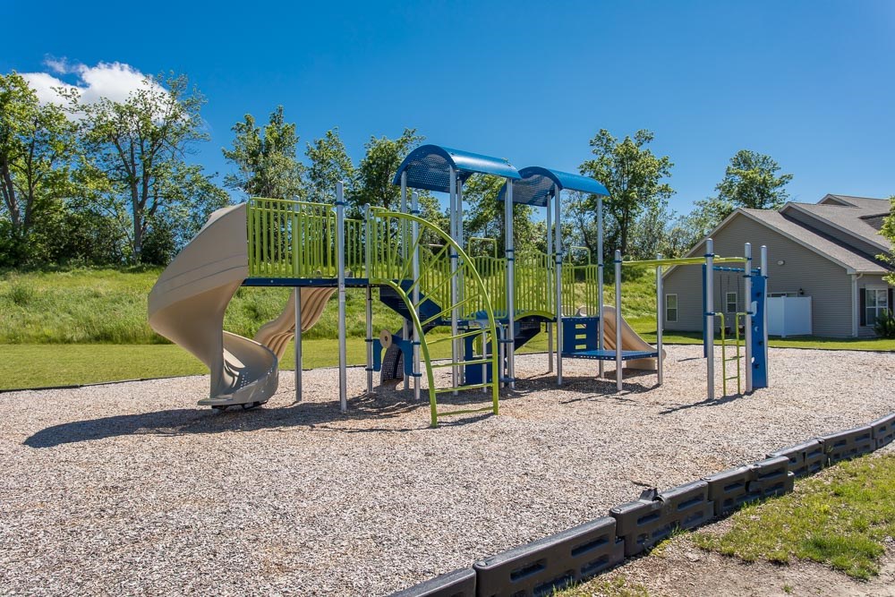 a playground with a slide and a swing set