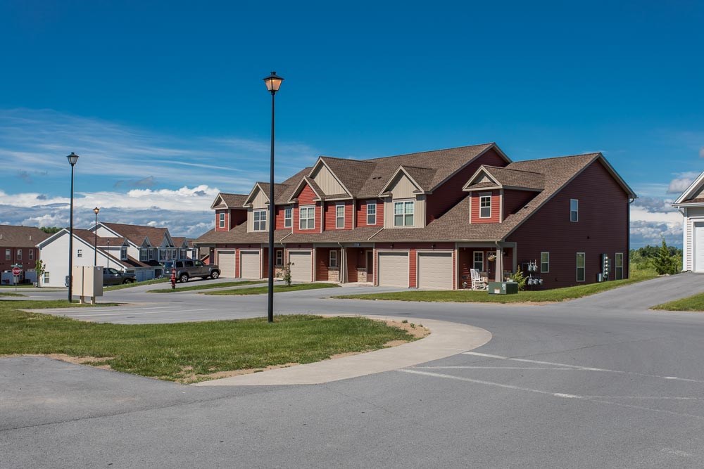 a row of houses on the corner of a street
