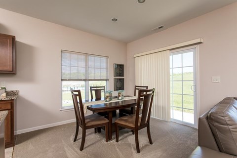 a dining room with a table and chairs and a couch