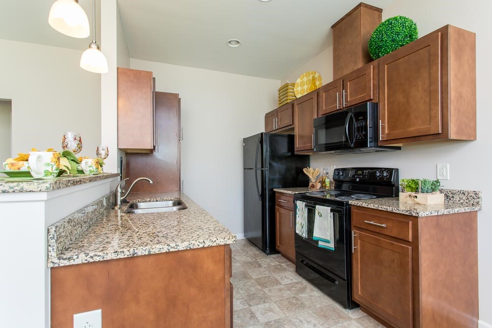 a kitchen with black appliances and granite counter tops