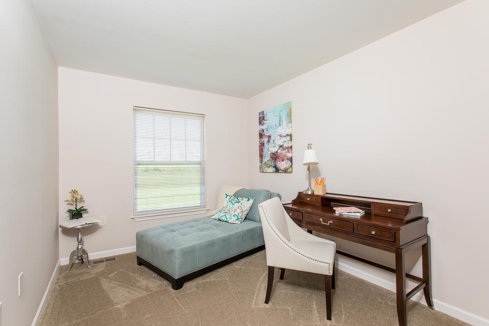 a bedroom with a bed and a dresser and a piano